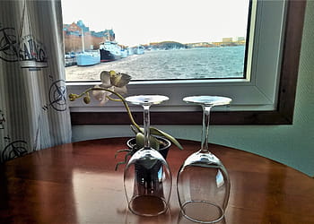 two, clear, wine glasses, table, on the ship, inside, under the roof, room, window, for two, no one