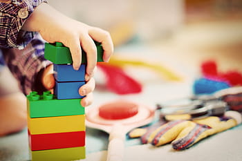 person, holding, lego blocks, child, tower, wooden blocks, kindergarten, play, toys, children, clutter