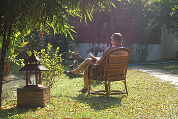 man, sitting, armchair, garden, daytime, reading, contemplative, contemplation, book, thinking, read
