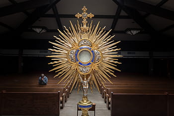 gold-colored crucifix cathedral decor, brown, blue, church, relic, dark, people, praying, man, monstrance, altar