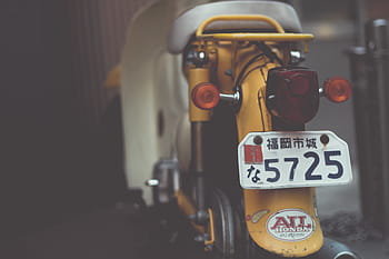 selective, focus photography, yellow, motor scooter, motor, scooter, vehicle, park, plate, number, blur