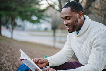 people, man, guy, smile, happy, reading, book, sitting, outside, black, african american