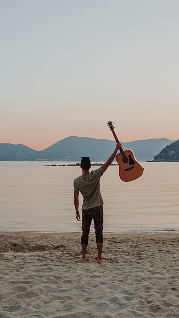 man, standing, seashore, holding, guitar, raised, daytime, music, beach, italy, notes