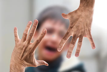 tilt shift lens photo, hands, holding, boy, face, violent, woman, man, hand, beat, child