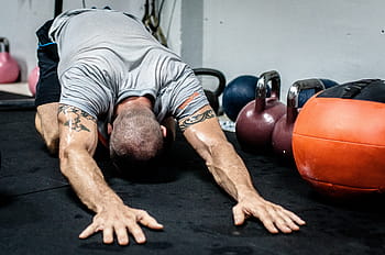 body builder, laying, hands, floor, kettle dumbbells, kettlebell, stretching, fitness, crossfit, fit, exercise