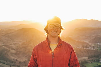 glasses, with smile standing, sunlit mountains, Man, smile, standing, sunlit, mountains, people, light, nature