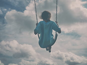 person, riding, swing, cloudy, sky, daytime, woman, wearing, blue, shirt, sitting
