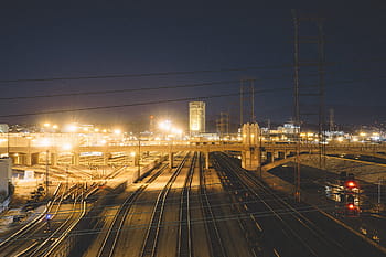 lighted, gray, concrete, bridge, road, city, roads, nighttime, train tracks, railroad, railway