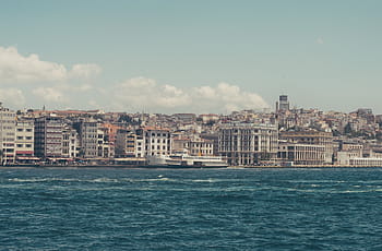 high, rise buildings, body, water, daytime, nature, landscape, ocean, sea, beach, clouds