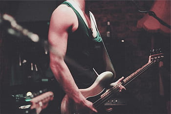 man, playing, electric, bass guitar, black, tank, top, standing, brown, guitar, inside