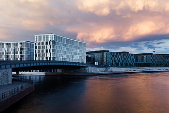 white, commercial, building, bridge, daytime, concrete, near, body, water, cloudy, sky