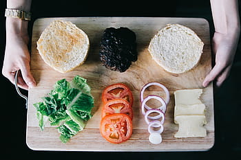 person, holding, brown, wooden, board, burger, ingredients, food, cook, onion, spices