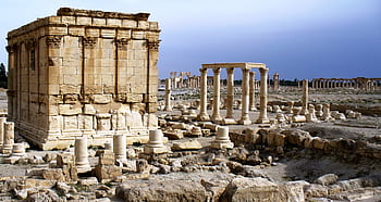 beige concrete buildings, ancient ruins, historical architecture, stone columns, archaeological site, desert landscape, classical architecture, ancient civilization, historical site, stone structures, ancient ruins site