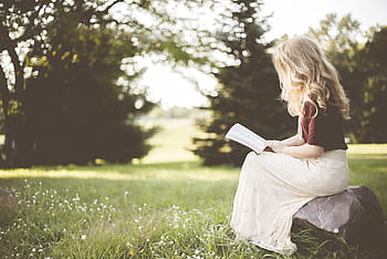 girl reading book, sits, rock, blond, blonde, girl, grass, outdoors, person, reading, woman