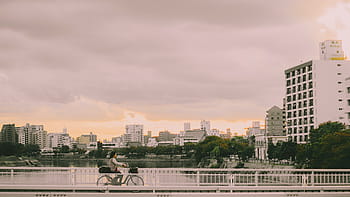 photography, person, riding, bike, bridge, architecture, building, infrastructure, sky, skyscraper, tower