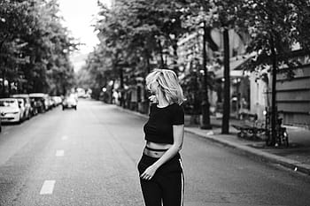 grayscale photo, woman, walking, streets, people, girl, alone, road, street, car, vehicle
