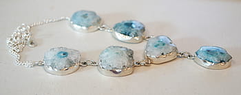 silver-colored teal stone necklace, white, board, solar quartz geode, stone, necklace, blue, gem, gemstone, natural, cabochon
